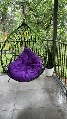 a purple pillow in a swing on a porch at The Hive at Druv Dakshin Farm Resort in Padinjarathara