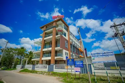 a building with a sign on top of it at My Rooms Channapatna in Channapatna