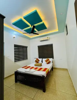 a bedroom with a bed with a ceiling at Diamond Villa Near Rajagiri Hospital in Alwaye
