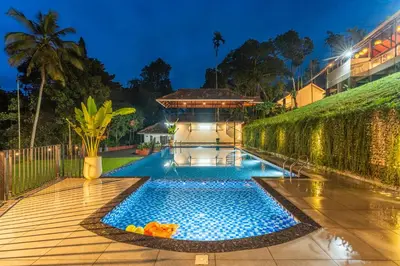 a swimming pool in the middle of a yard at Theyila Wayanad Premium Pool Resort in Sultan Bathery