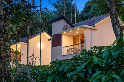 a house in the woods with a balcony at Theyila Wayanad Premium Pool Resort in Sultan Bathery