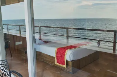 a bed on the balcony of a cruise ship at The Cabana in Cherai Beach