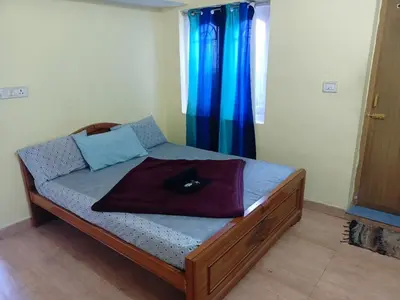 a small bedroom with a bed with at Valley homes in Ooty