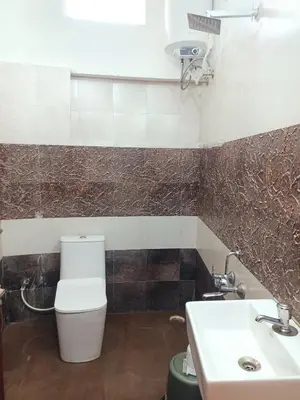 a bathroom with a toilet and a sink at Valley homes in Ooty