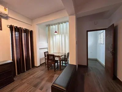 a room with a table and chairs and a dining room at DB Apartment Arimpur in Trichūr