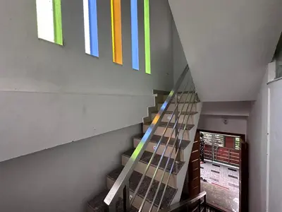 a staircase with colorful stripes on the wall at DB Apartment Arimpur in Trichūr