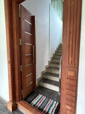 an open door leading to a stairway with a staircase at DB Apartment Arimpur in Trichūr