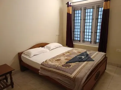 a bedroom with a bed with a robe on it at Abbu Royal Palace Cottage in Ooty