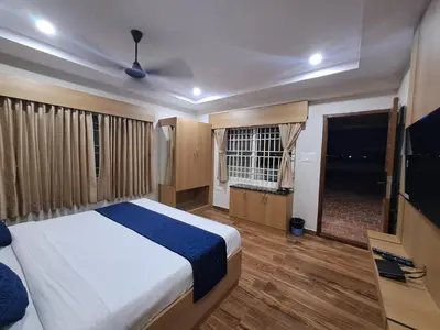 a bedroom with a bed and a television in it at Sky Inn in Mysore