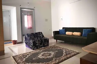 a living room with a couch and a chair at Royal King Bed Suite, Service Apartments, 1km to center , Free WI-FI in Mysore