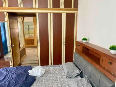 a bedroom with a bed and a closet and a mirror at Royal King Bed Suite, Service Apartments, 1km to center , Free WI-FI in Mysore