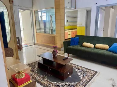 a living room with a green couch and a coffee table at Royal King Bed Suite, Service Apartments, 1km to center , Free WI-FI in Mysore
