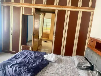 a bedroom with a bed and a mirror and a dresser at Royal King Bed Suite, Service Apartments, 1km to center , Free WI-FI in Mysore
