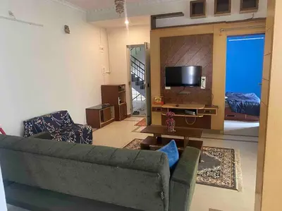 a living room with a couch and a flat screen tv at Royal King Bed Suite, Service Apartments, 1km to center , Free WI-FI in Mysore