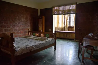 a bedroom with a bed and a large window at Lakshmi illam Near Isha Yoga Adiyogi in Alāndurai