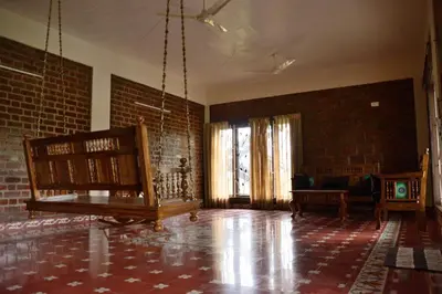 an empty room with a couch and a brick wall at Lakshmi illam Near Isha Yoga Adiyogi in Alāndurai