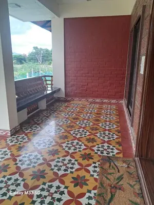 a hallway with a colorful tile floor with a bench at Lakshmi illam Near Isha Yoga Adiyogi in Alāndurai