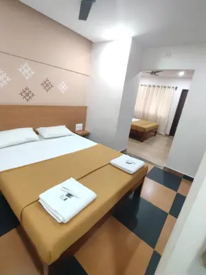 a room with a bed with two towels on it at Nandan Residency in Mysore
