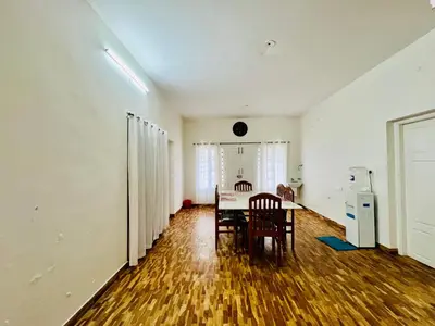 a kitchen and dining room with a table and chairs at Teyt's Green Haven - 3 BHK in Ooty