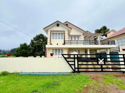 a house with a gate and a fence at Teyt's Green Haven - 3 BHK in Ooty