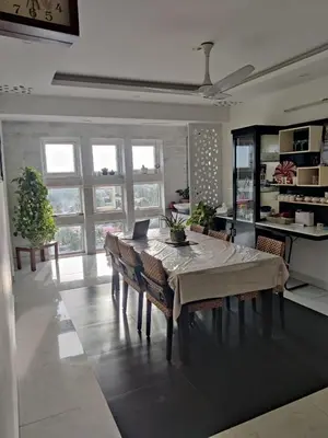 a dining room with a table with a laptop on it at Urban Oasis in Trichūr