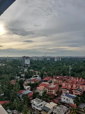 an aerial view of a city with buildings and trees at Urban Oasis in Trichūr