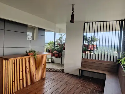 a room with a balcony with a bench and a window at Urban Oasis in Trichūr