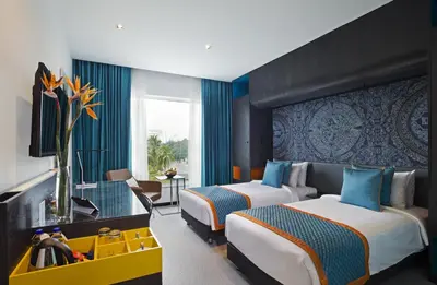 a hotel room with two beds and a window at Zone By The Park Coimbatore in Coimbatore