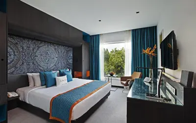 a hotel room with a large bed and a window at Zone By The Park Coimbatore in Coimbatore