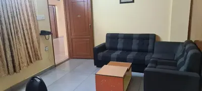 a living room with a couch and a chair at Prestige Tourist Home in Nedumbassery