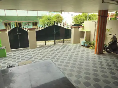 a room with a gate and a tiled floor at Honeycomb Homestay Ground Floor in Palani