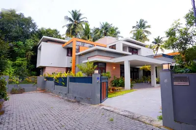 a house with a fence in front of it at Sannidhi Homes Palakkad in Palakkad