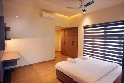 a bedroom with a large bed and a window at Sannidhi Homes Palakkad in Palakkad