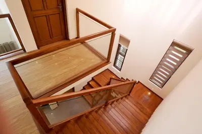 an overhead view of a wooden staircase with a door at Sannidhi Homes Palakkad in Palakkad