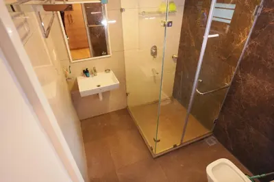 a bathroom with a shower and a sink at Sannidhi Homes Palakkad in Palakkad