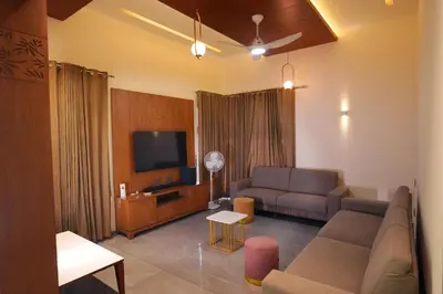 a living room with a couch and a tv at Sannidhi Homes Palakkad in Palakkad
