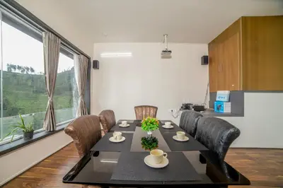 a dining room with a black table and chairs at Abhinav Nest by Xplore Indo in Kodanād