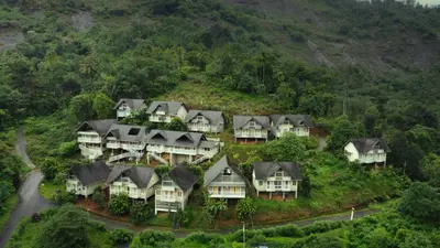 an aerial view of a bunch of houses on a hill at Rains Valley Resort By Teal Luxury Stays in Viripara