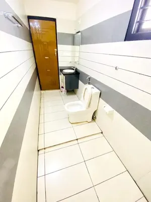 a bathroom with a toilet in a stall at Albis Ville Ooty in Ooty