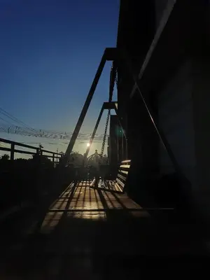 a person walking across a bridge at sunset at Albis Ville Ooty in Ooty