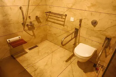 a bathroom with a toilet and a shower at Sahya Regency in Ottappālam
