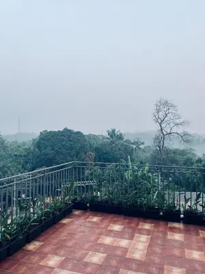 a balcony with a view of a forest at Sahya Regency in Ottappālam