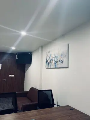 a living room with a couch and a painting on the wall at Sahya Regency in Ottappālam