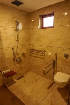 a bathroom with a shower and a toilet at Sahya Regency in Ottappālam