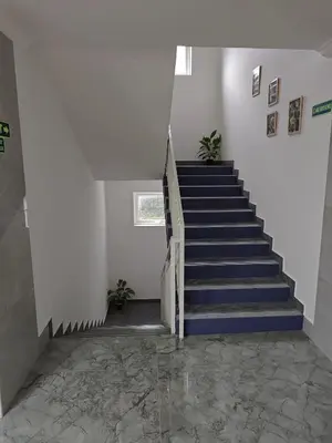 a staircase with blue steps in a white room at 7 Elysee Homestay - Lapis - Premium 3BHK Family Flat in Trichūr