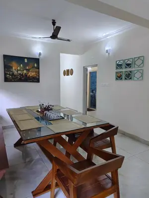 a dining room with a table and a ceiling at 7 Elysee Homestay - Lapis - Premium 3BHK Family Flat in Trichūr