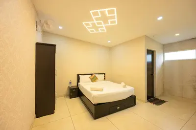 a bedroom with a bed in a room at River Serene Holiday home in Kizhake Chālakudi