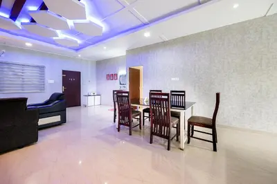 a dining room with a table and chairs at River Serene Holiday home in Kizhake Chālakudi
