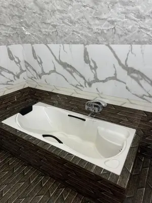 a white sink in a bathroom with a counter at River Serene Holiday home in Kizhake Chālakudi