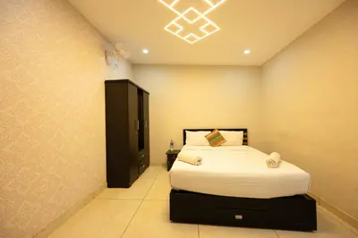 a bedroom with a bed and a television in it at River Serene Holiday home in Kizhake Chālakudi